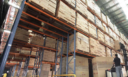 Boxes are arranged on the warehouse shelves of a home furniture wholesale supplier.